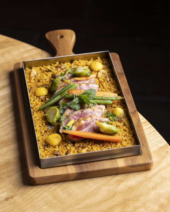 Paella with meat and vegetables in the pan